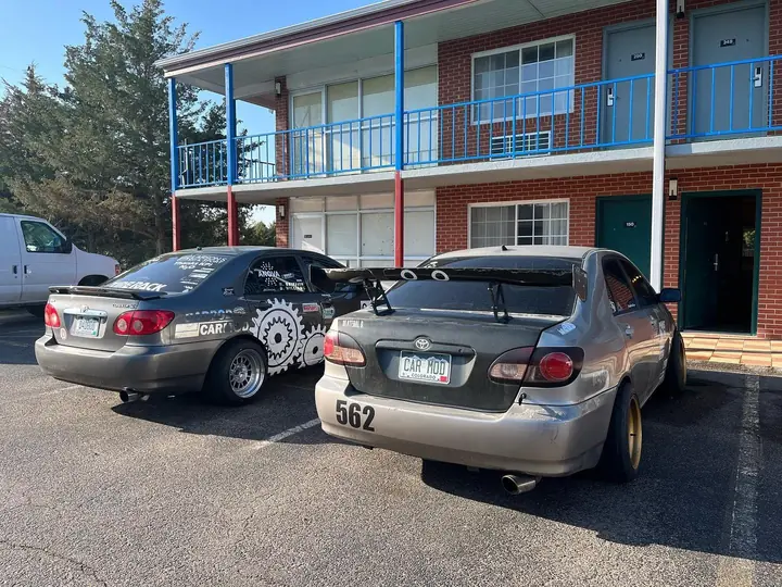 Two gray Dadbod Carmod Toyota Corollas parked together during a road stop